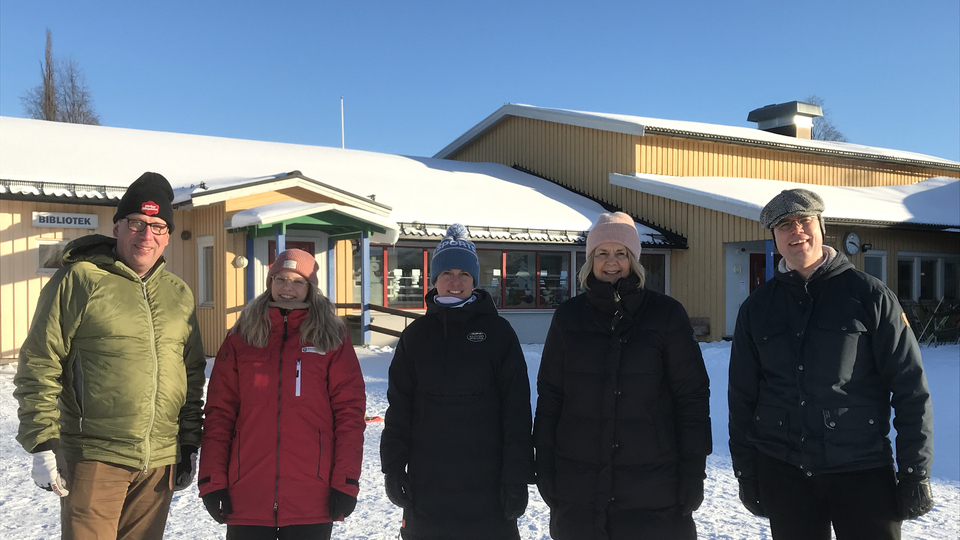 Fem personer i vinterkläder utanför skolan i Vemdalen.